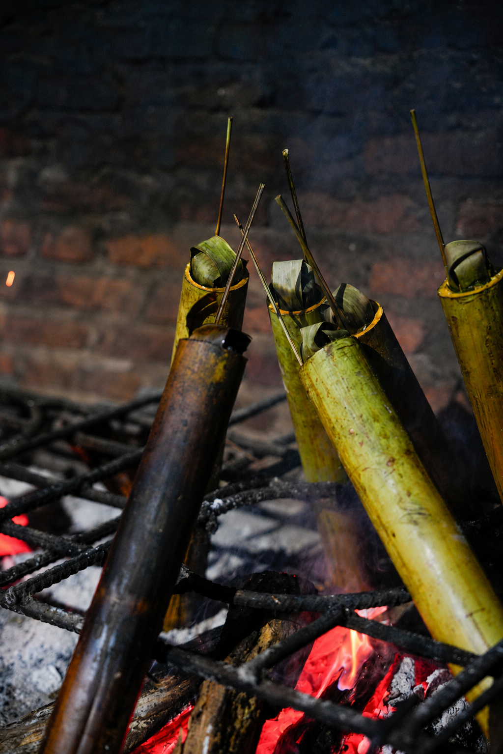 Bamboo tubes cooking over the wood fire